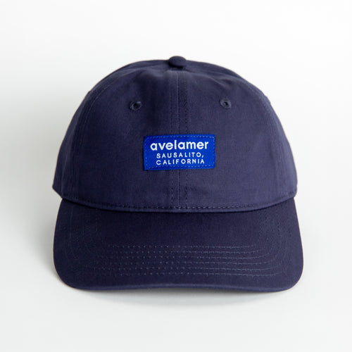 Front view of an Avelamer Bridgeway Cap in Deepwater (navy) with a tonal Avelamer brand woven label on the front panel