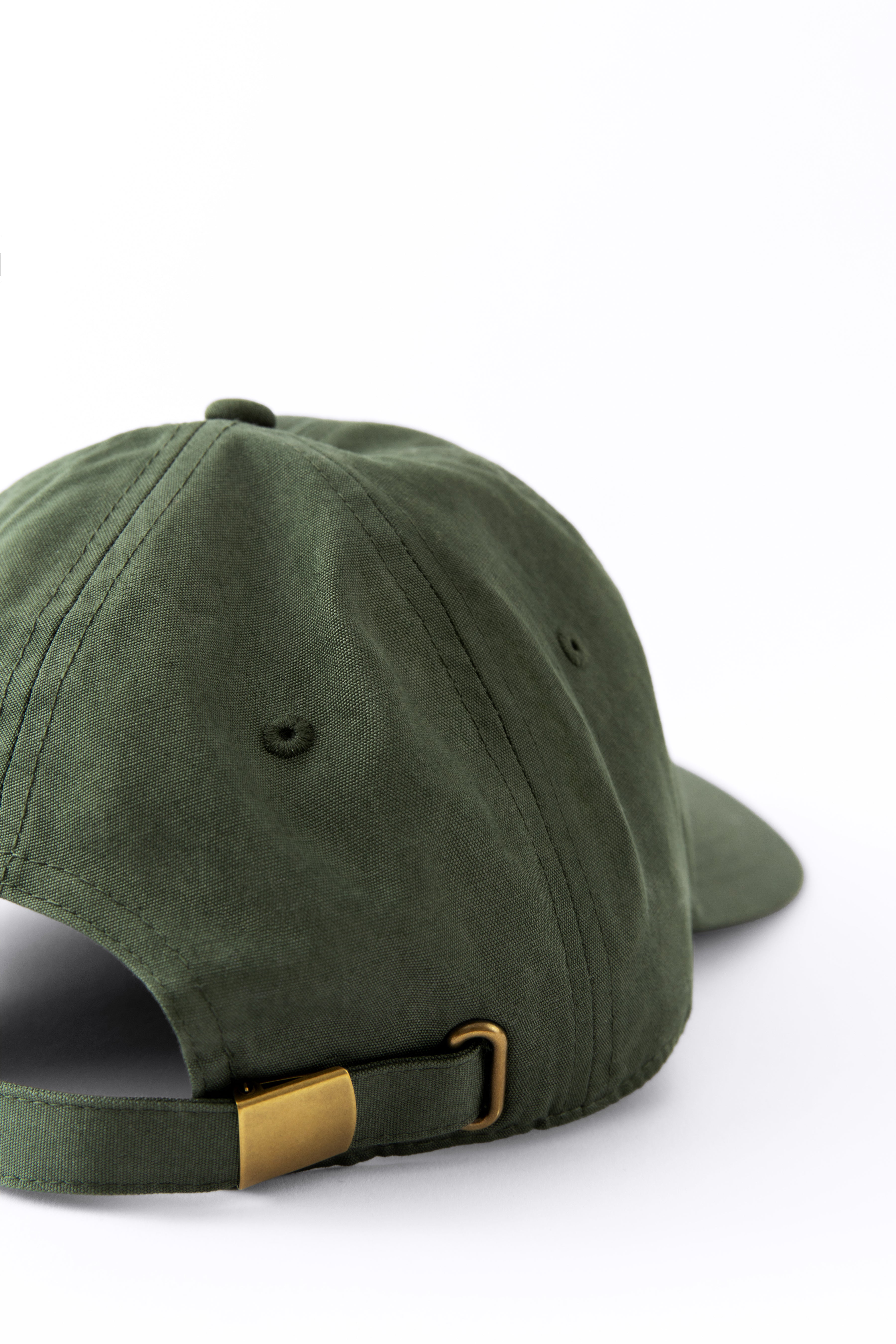 Back view of an Avelamer Caledonia Cap in Cypress Grove green with gold buckle on a white background