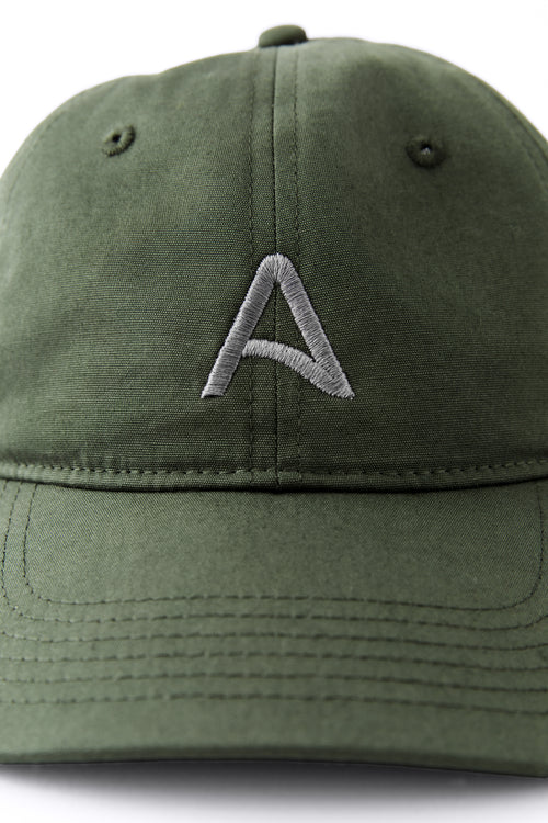 Front view of an Avelamer Caledonia Cap in Cypress Grove green with embroidered gray A-flag logo on a white background