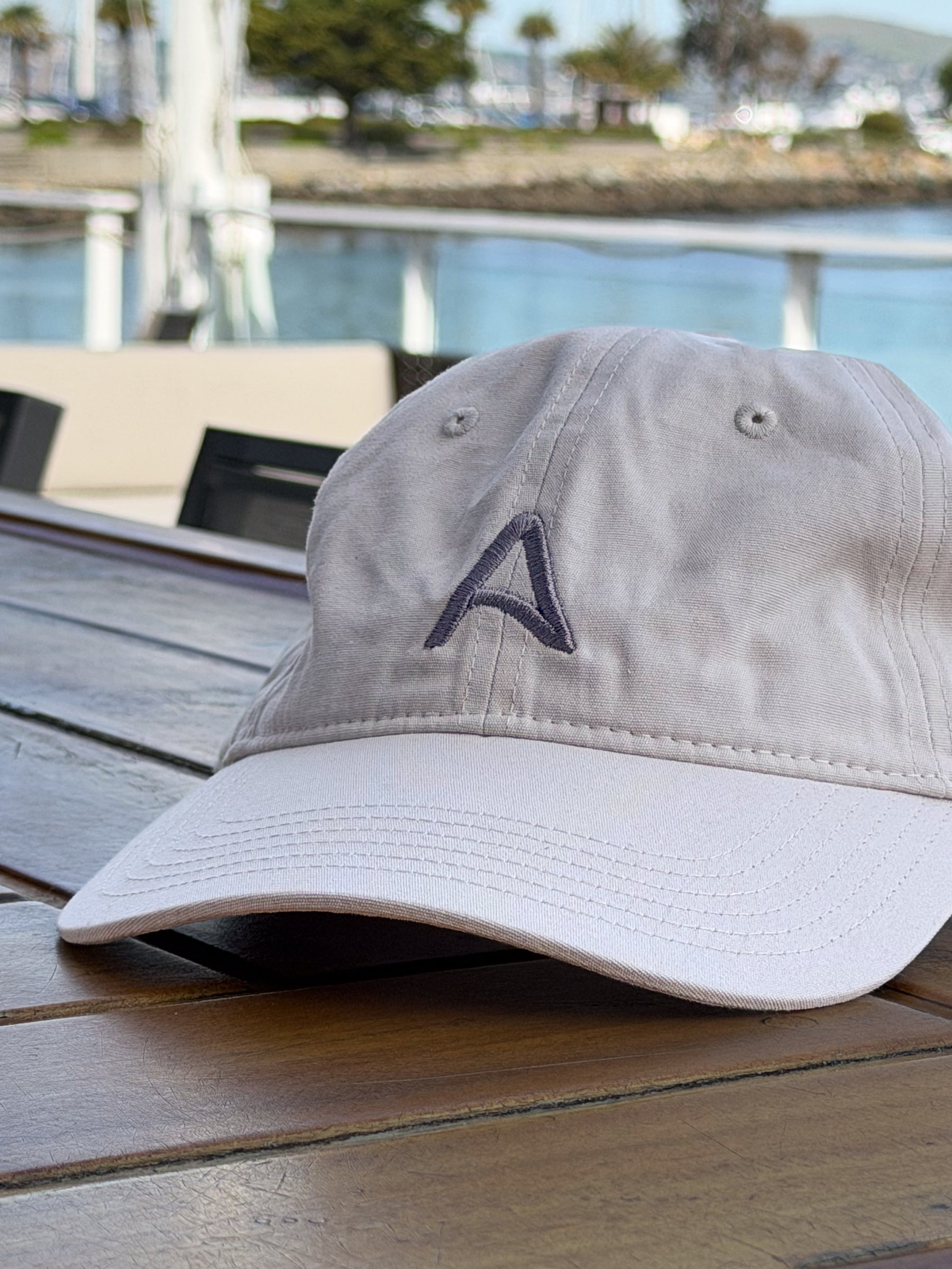 Mainsail off-white cap on a bar overlooking the bay