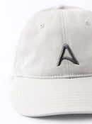 Front view of an Avelamer Caledonia Cap in Mainsail off-white with embroidered gray A-flag logo on a white background