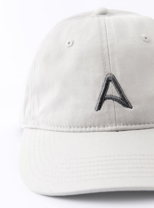 Front view of an Avelamer Caledonia Cap in Mainsail off-white with embroidered gray A-flag logo on a white background