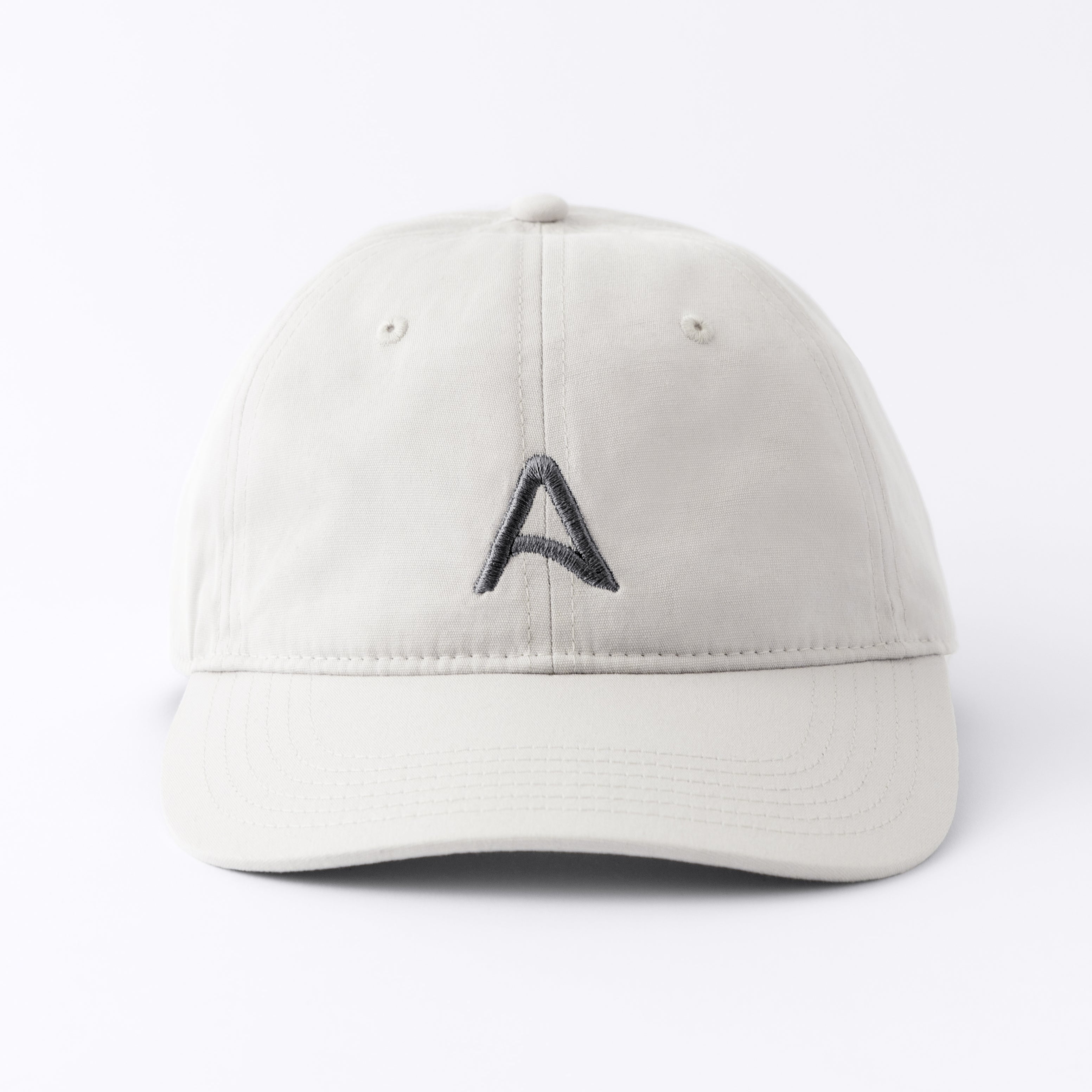 Front view of an Avelamer Caledonia Cap in Mainsail off-white with embroidered gray A-flag logo on a white background