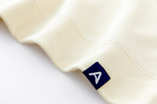 Avelamer Cazneau Crew sweatshirt in Mainsail off-white with a blue Avelamer A-flag woven hem label.