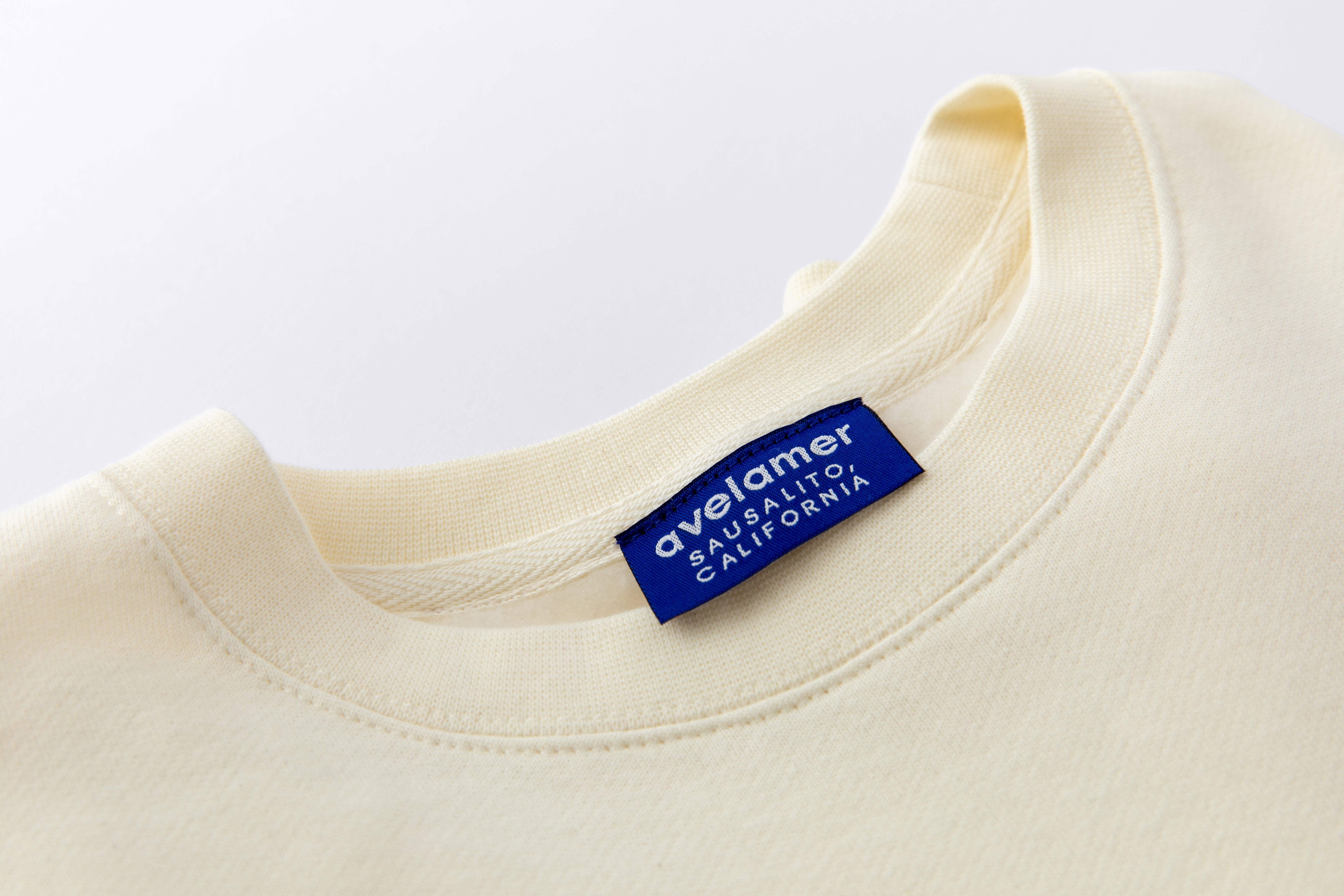 Avelamer Cazneau Crew sweatshirt in Mainsail off-white with a blue Avelamer Sausalito, California woven neck label.