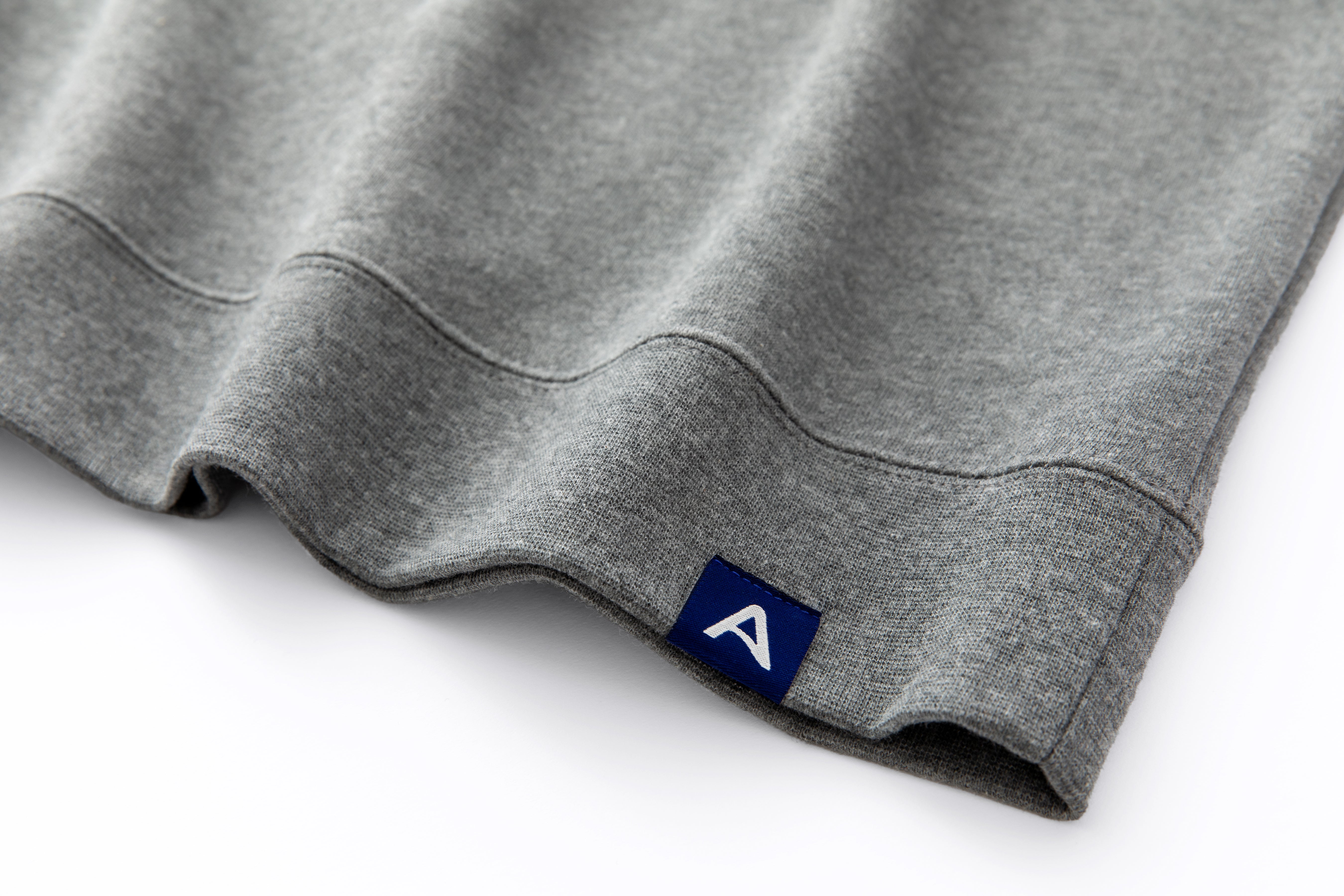 Avelamer Cazneau Crew sweatshirt in Morning Fog heather gray with a blue A-flag woven hem label.