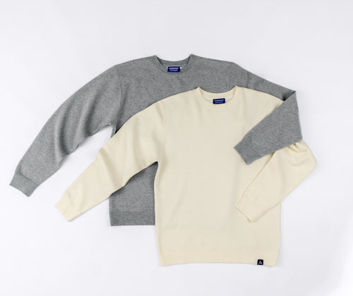 Two stacked Avelamer Cazneau Crew sweatshirts in Mainsail off-white and Morning Fog heather gray blue Avelamer Sausalito, California woven neck labels and A-flag hem labels. 