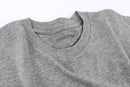 Close-up of Avelamer Ebbtide Tee in Morning Fog heather gray with printed neck label