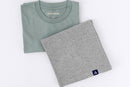 Folded blue-green and heather gray tees with woven A-flag brand hem labels on a white background.