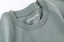 Close-up of Avelamer Ebbtide Tee in Shallow Bay blue-green with printed neck label