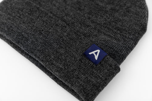 Avelamer Harbor Beanie in Headland Shadow dark gray with blue A-flag logo woven cuff label