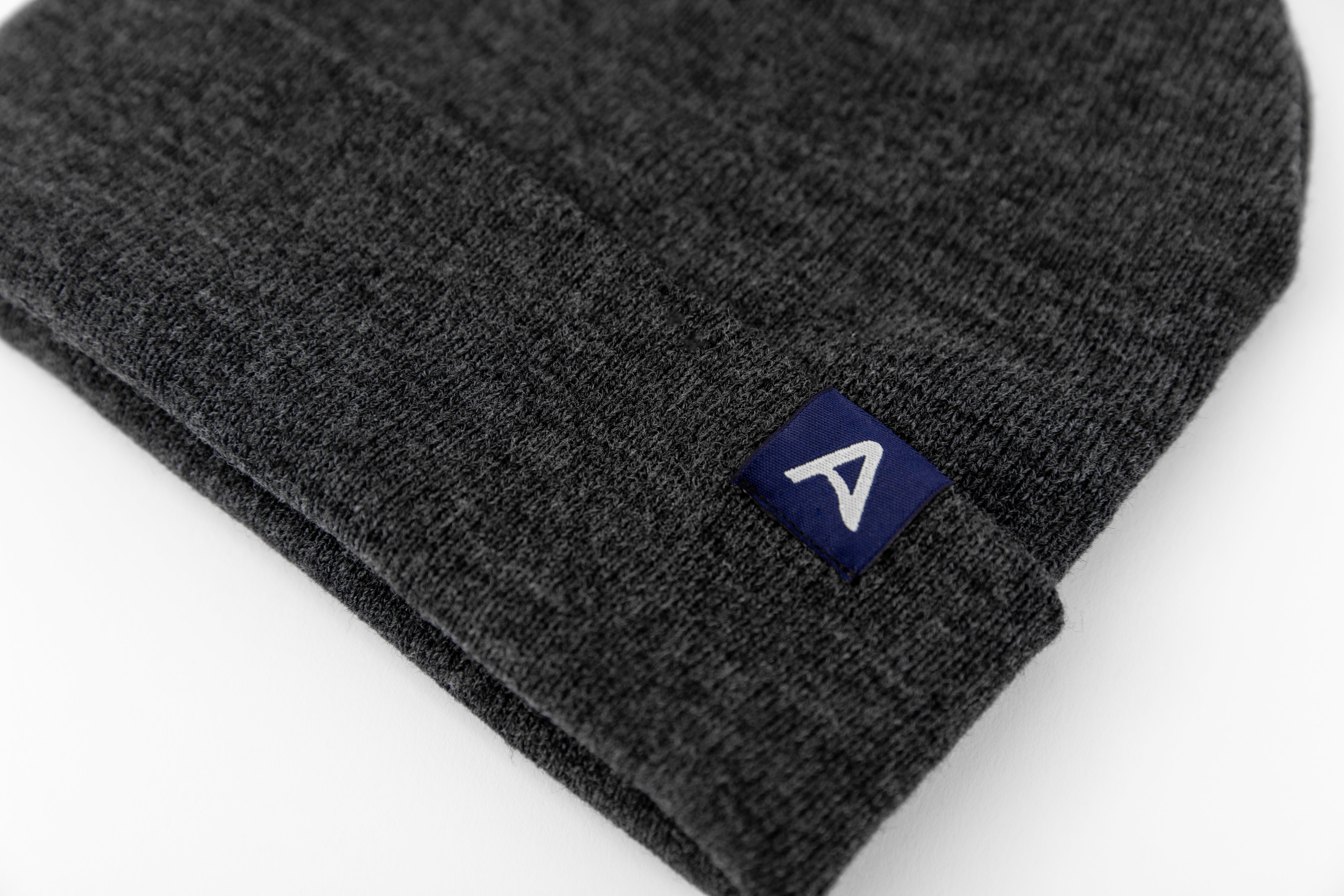 Avelamer Harbor Beanie in Headland Shadow dark gray with blue A-flag logo woven cuff label