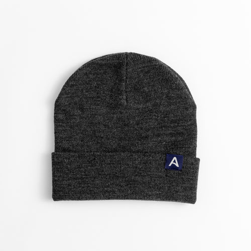Avelamer Harbor Beanie in Headland Shadow dark gray with blue A-flag logo woven cuff label laid flat on a white background