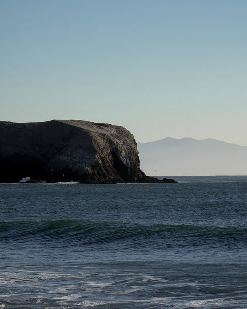 Shadow side of the Marin Headlands extending into the Pacific Ocean