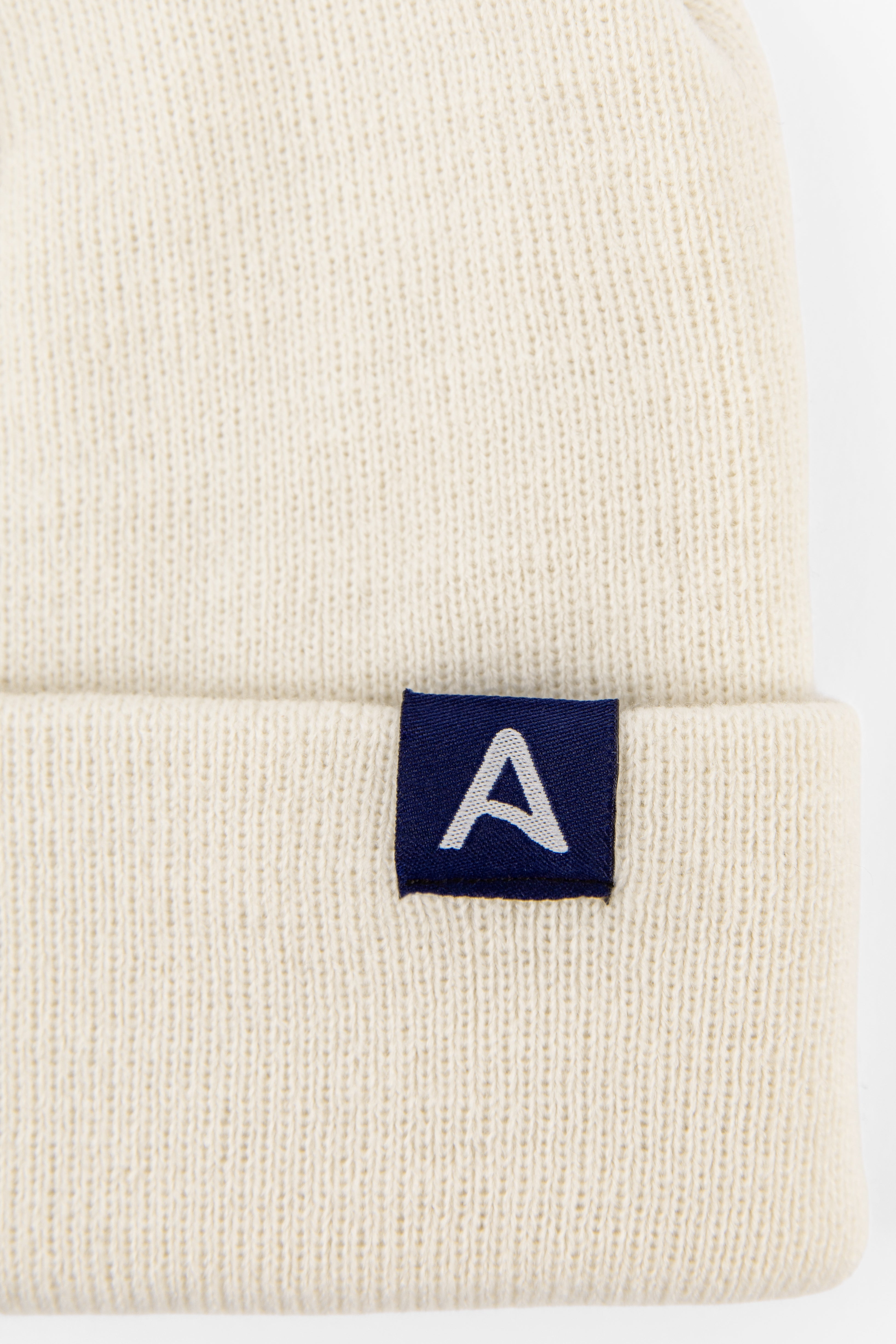 Avelamer Harbor Beanie in Mainsail off-white with blue A-flag logo woven cuff label