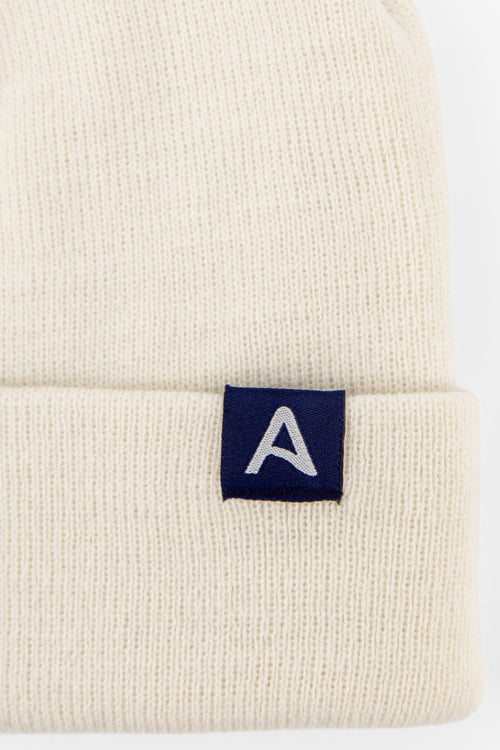 Avelamer Harbor Beanie in Mainsail off-white with blue A-flag logo woven cuff label