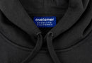 Close-up of Avelamer Sausalito Hoodie in Headland Shadow dark gray with a woven branded neck label