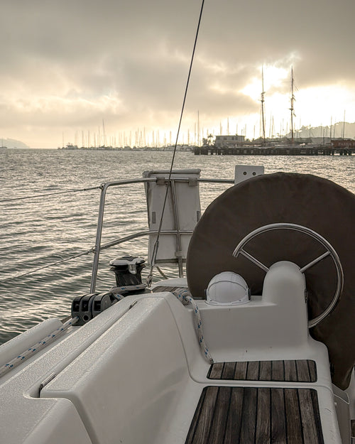 Sailboat in a Sausalito marina looking back on San Francisco Bay with fog on the horizon.