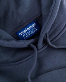 Close-up of Avelamer Sausalito Hoodie in Ocean Slate blue-gray with a woven branded neck label 