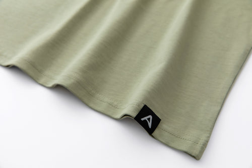 Avelamer Spencer Long Sleeve tee in Bluff Sage light green with a blue A-flag woven hem label.