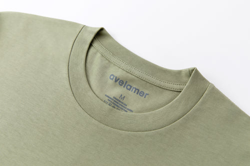 Avelamer Spencer Long Sleeve tee in Bluff Sage light green with a gray printed Avelamer neck label. 
