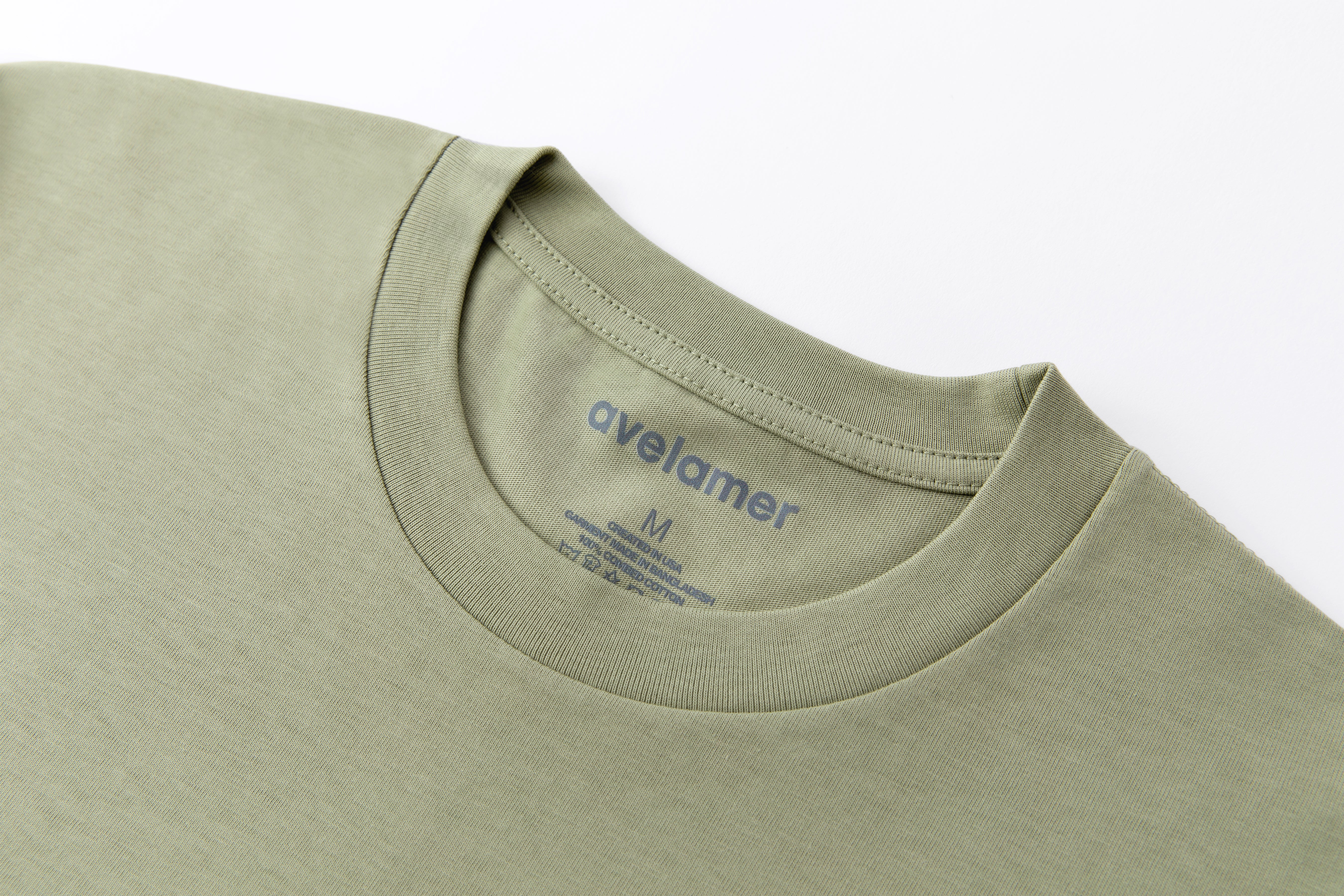 Avelamer Spencer Long Sleeve tee in Bluff Sage light green with a gray printed Avelamer neck label. 